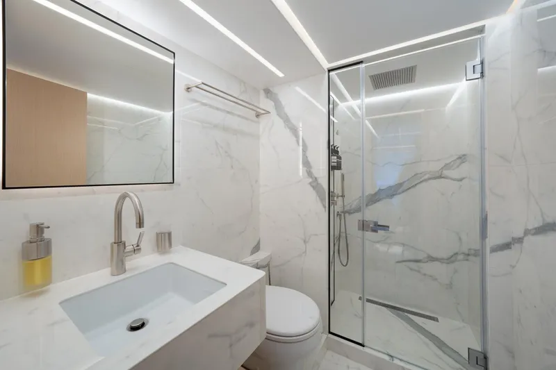 Slide: The Image of Modern bathroom on Majesty 100 yacht, 2020 model, featuring marble walls and glass shower. - 10