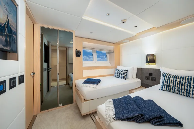 Slide: The Image of Luxurious twin bedroom on the 2020 Majesty 100 yacht with modern decor. - 11