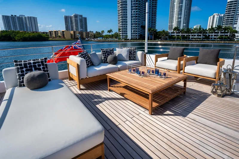 Slide: The Image of Luxurious deck seating on a 2020 Majesty 100 yacht with cityscape views. - 17