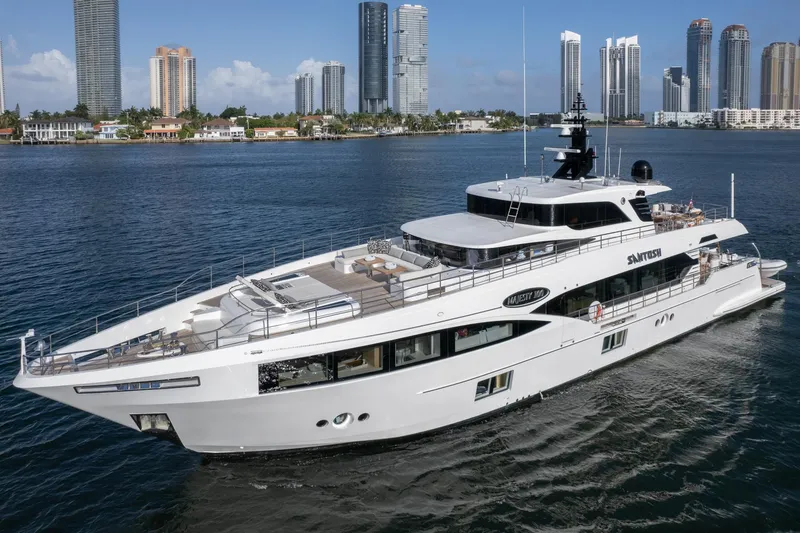 Slide: The Image of Majesty 100 yacht cruising near a city skyline, 2020 model. - 25