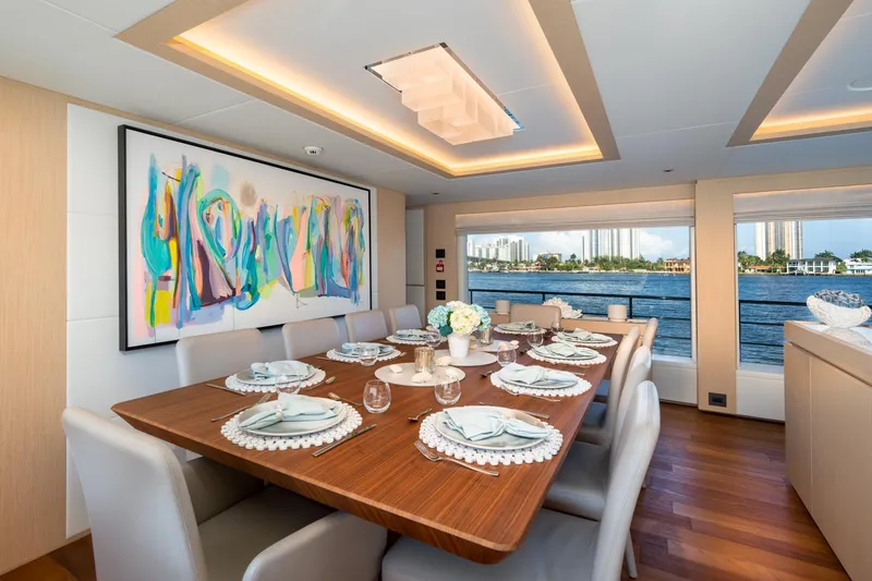 Slide: The Image of Luxurious dining area on 2020 Majesty 100 yacht with modern art and waterfront view. - 4