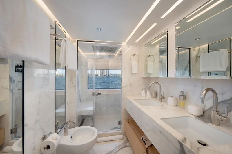 Slide: The Image of Luxurious bathroom on a 2020 Majesty 100 yacht with marble finishes and dual sinks. - 6