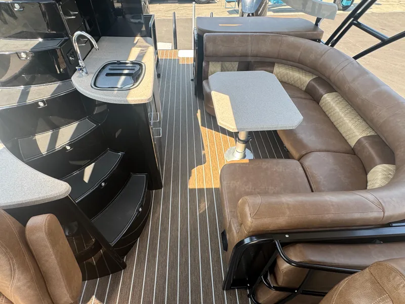 Slide: The Image of Luxurious 2026 Premier Escalante boat interior with brown seating, kitchenette, and table. - 10