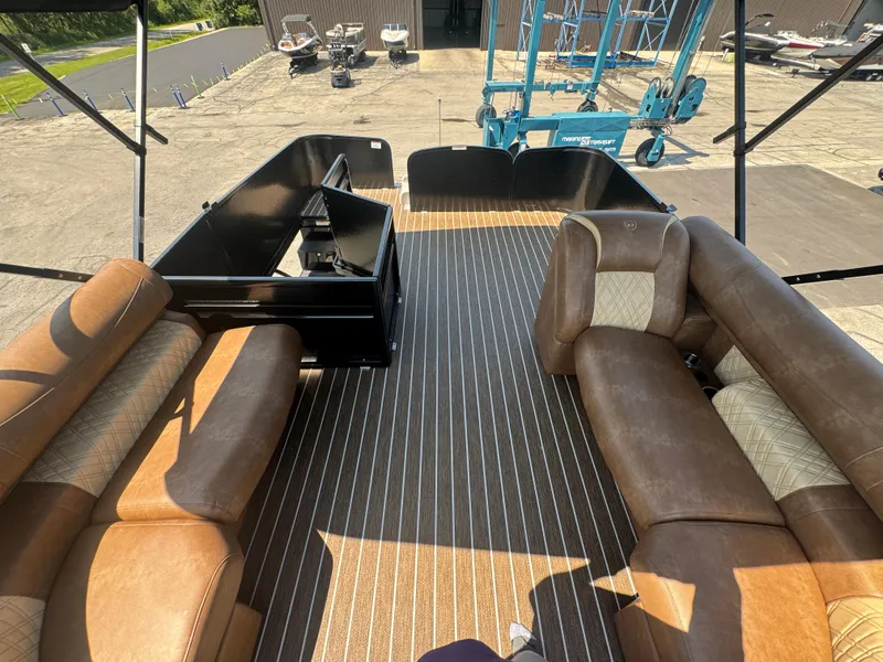 Slide: The Image of 2026 Premier Escalante boat interior with brown seating and striped flooring. - 13
