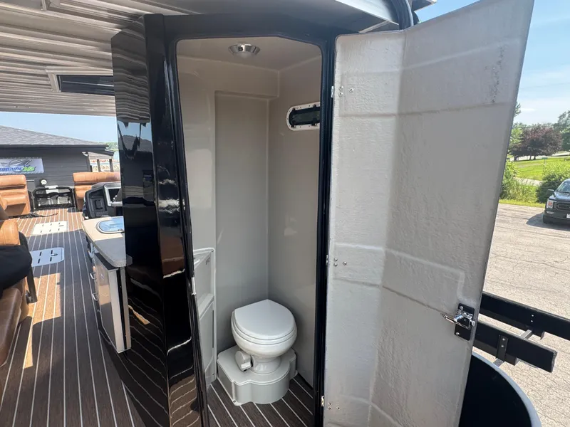 Slide: The Image of 2026 Premier Escalante boat interior with compact bathroom and modern amenities. - 17