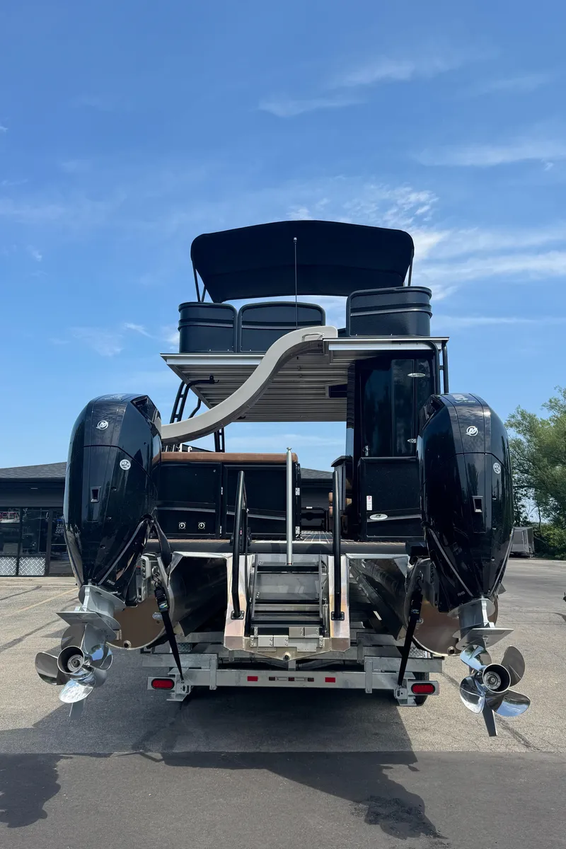 Slide: The Image of 2026 Premier Escalante boat with dual outboard motors, viewed from the rear on a trailer. - 2