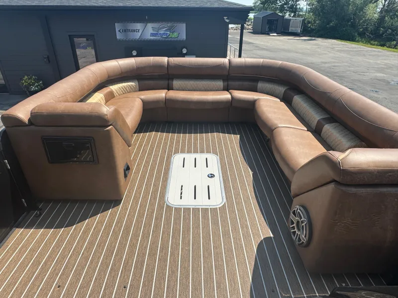 Slide: The Image of Luxurious seating area on 2026 Premier Escalante boat with brown upholstery and striped flooring. - 21