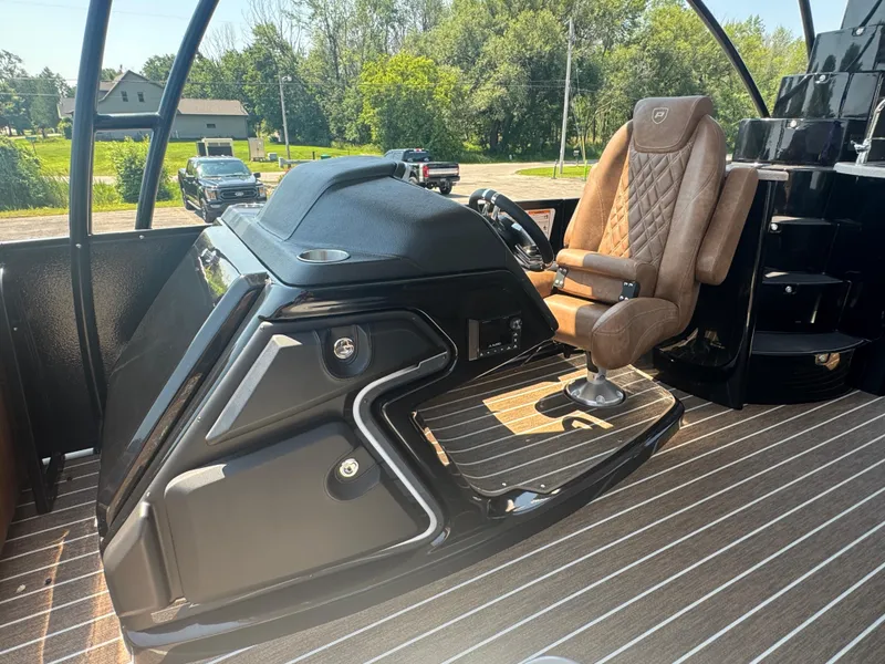 Slide: The Image of 2026 Premier Escalante boat interior with luxurious captain's chair and sleek dashboard design. - 23