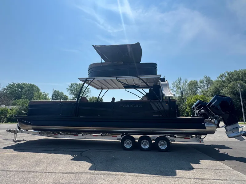 Slide: The Image of 2026 Premier Escalante pontoon boat on trailer under clear blue sky. - 4
