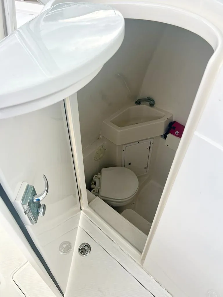 Slide: The Image of 2013 Jupiter 34 Center Console boat interior bathroom with sink and toilet. - 10