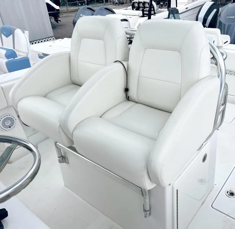 Slide: The Image of 2013 Jupiter 34 Center Console boat with white dual captain's chairs. - 11