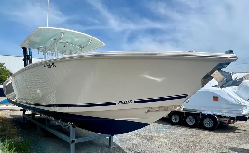 Slide: The Image of 2013 Jupiter 34 Center Console boat on trailer under blue sky. - 3