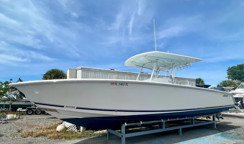 Slide: The Image of 2013 Jupiter 34 Center Console boat on a trailer under a clear blue sky. - 5