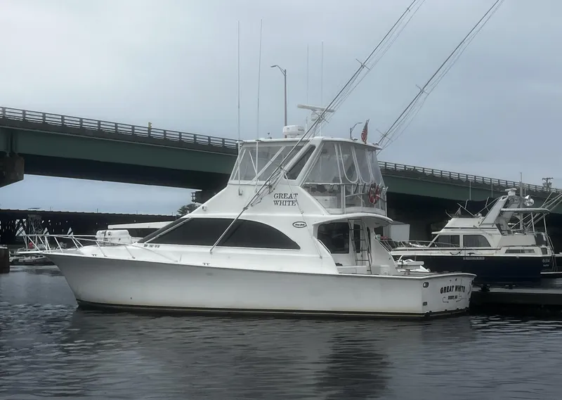 Slide: The Image of 2003 Ocean Yachts 48 Super Sport docked near a bridge. - 3