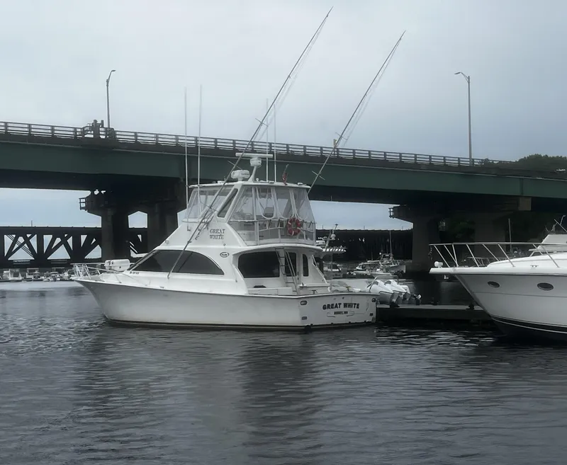 Slide: The Image of 2003 Ocean Yachts 48 Super Sport docked near a bridge on a cloudy day. - 4