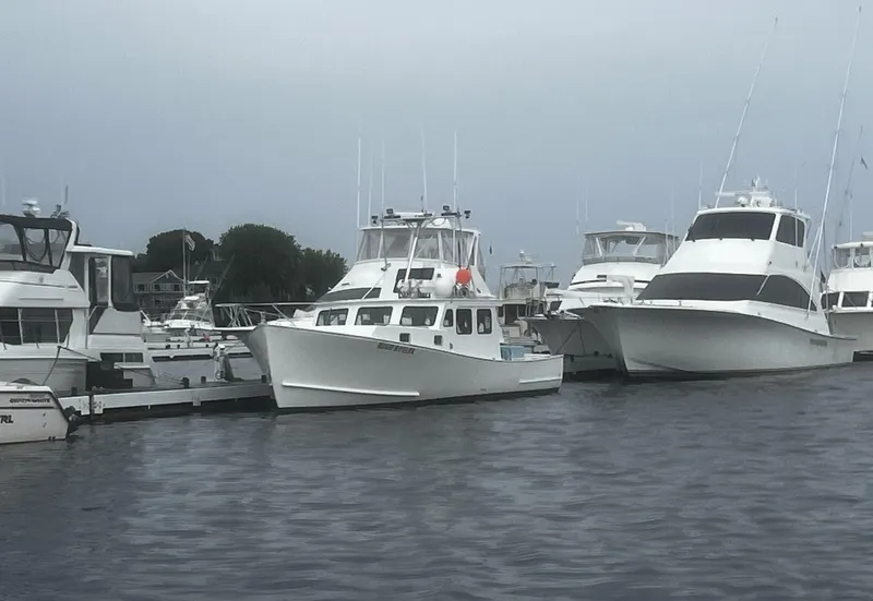Slide: The Image of Ocean Yachts 48 Super Sport 2003 docked among other boats in a marina. - 5