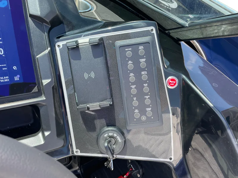 Slide: The Image of Control panel of 2024 Premier Supersport with key ignition and button interface. - 16