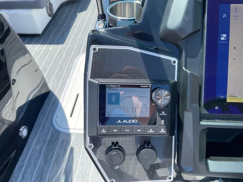 Slide: The Image of 2024 Premier Supersport dashboard with JL Audio system displaying FM 105.7. - 18