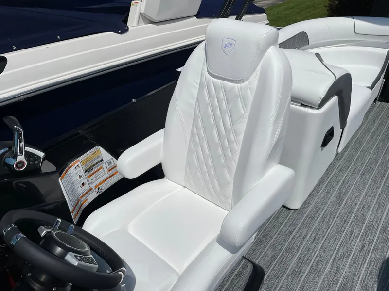 Slide: The Image of 2024 Premier Supersport boat interior with white leather seating and modern steering wheel. - 21