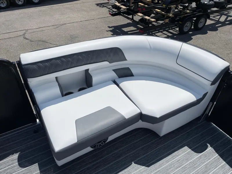 Slide: The Image of 2024 Premier Supersport boat seating with gray and white upholstery, featuring cup holders. - 27