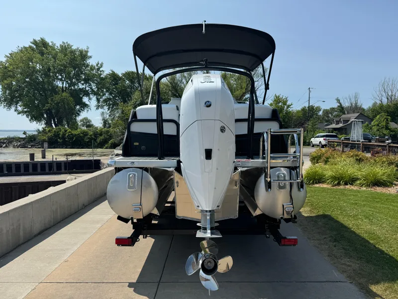 Slide: The Image of 2024 Premier Supersport pontoon boat with outboard motor, docked on a sunny day. - 3