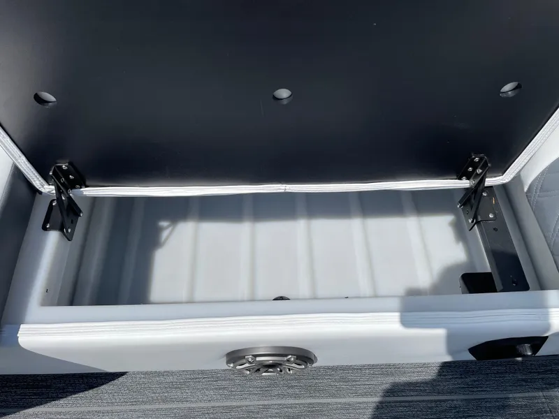 Slide: The Image of Open storage compartment in 2024 Premier Supersport boat, featuring durable hinges and spacious interior. - 35