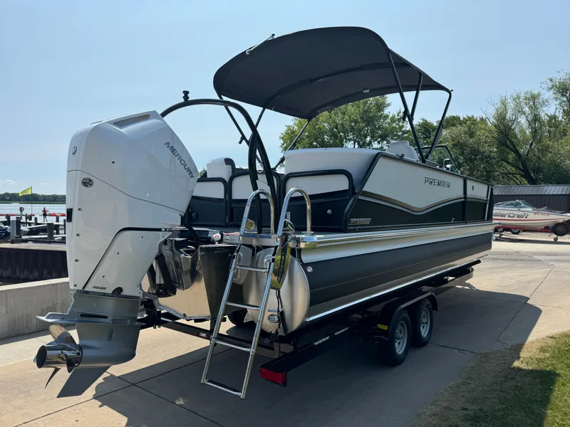 Slide: The Image of 2024 Premier Supersport pontoon boat with Mercury outboard engine on trailer. - 4