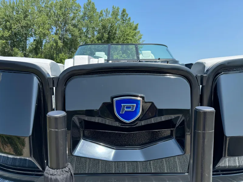 Slide: The Image of 2024 Premier Supersport boat with sleek black design and blue emblem, set against a clear sky. - 7