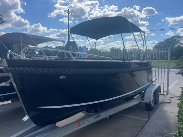 Slide: The Image of 2023 Maxima 620 Retro boat on trailer with canopy, parked outdoors. - 10