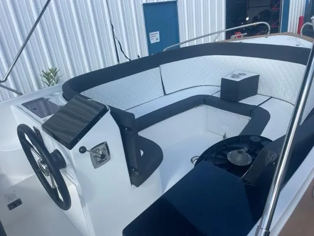 Slide: The Image of 2023 Maxima 620 Retro boat interior with white and black seating. - 11