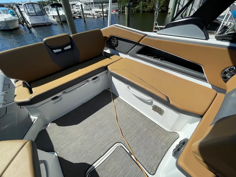 Slide: The Image of 2020 Scarab 285 ID boat interior with tan seating and docked at marina. - 13