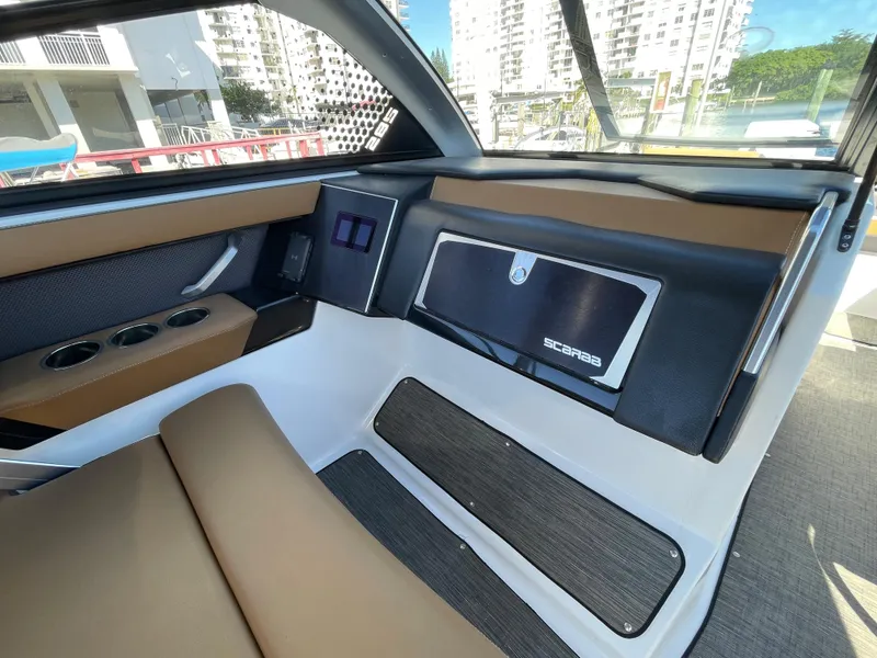 Slide: The Image of Interior of 2020 Scarab 285 ID boat with brown and black seating. - 19