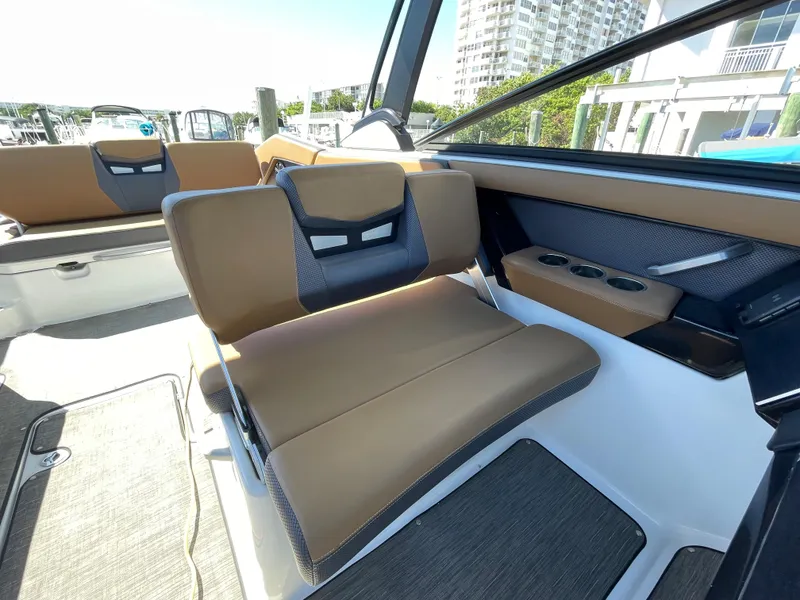 Slide: The Image of 2020 Scarab 285 ID boat interior with tan and black seating. - 20