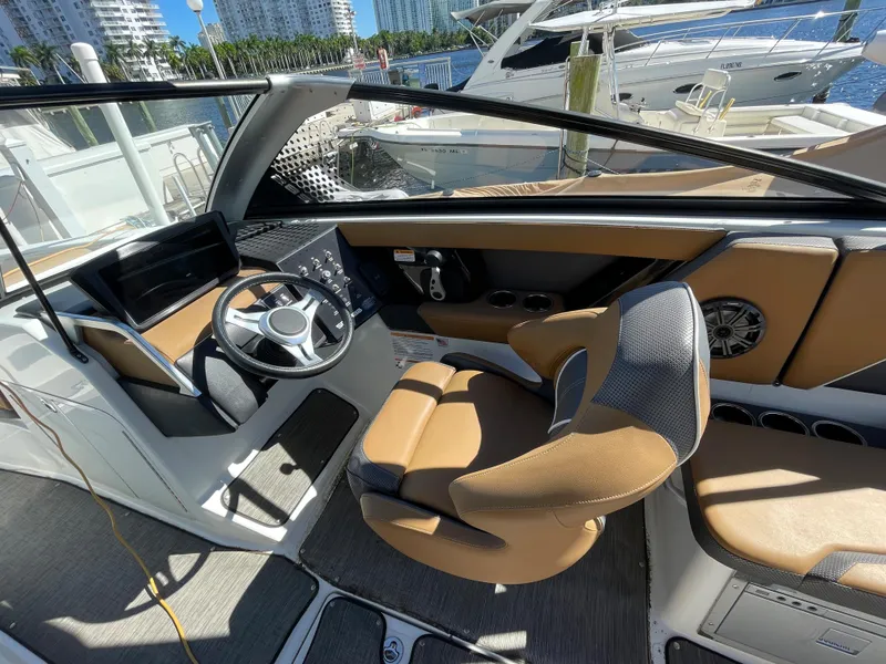 Slide: The Image of 2020 Scarab 285 ID boat interior with modern helm and tan seating. - 21