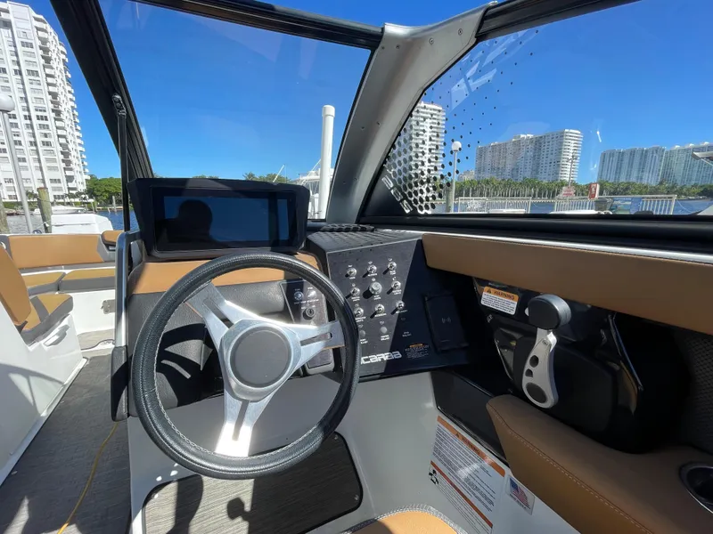 Slide: The Image of 2020 Scarab 285 ID boat cockpit with steering wheel and control panel. - 22