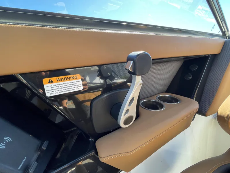 Slide: The Image of 2020 Scarab 285 ID boat throttle control and cup holders. - 24