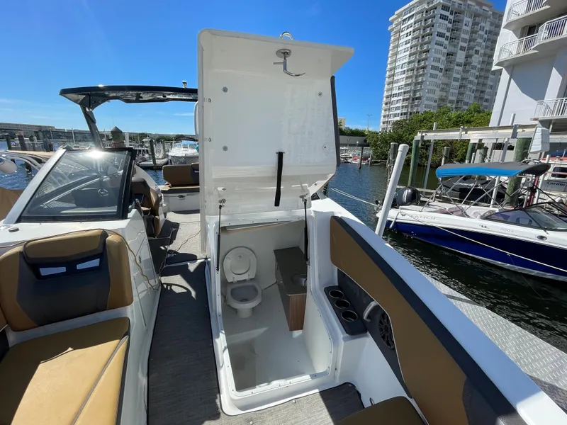 Slide: The Image of 2020 Scarab 285 ID boat with open bathroom compartment at marina. - 30