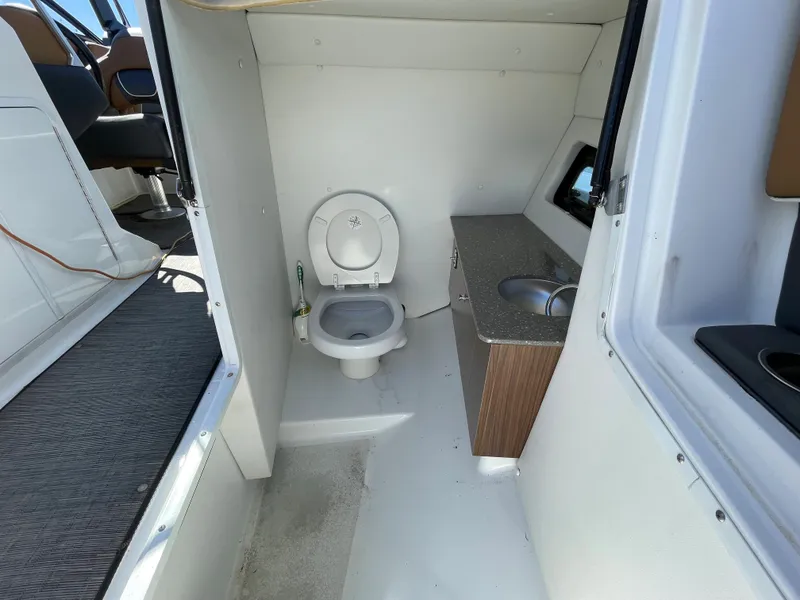 Slide: The Image of 2020 Scarab 285 ID boat interior bathroom with toilet and sink. - 31