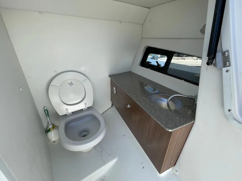 Slide: The Image of 2020 Scarab 285 ID boat bathroom with toilet, sink, and countertop. - 32