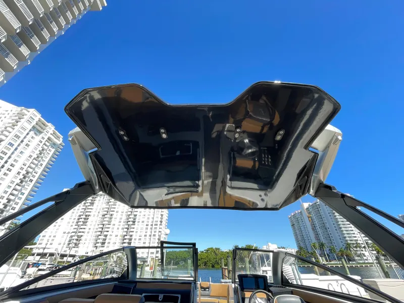 Slide: The Image of 2020 Scarab 285 ID boat with open canopy, city skyline background. - 40