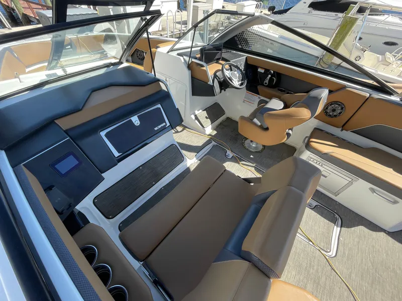 Slide: The Image of Interior of a 2020 Scarab 285 ID boat with tan and black seating. - 7