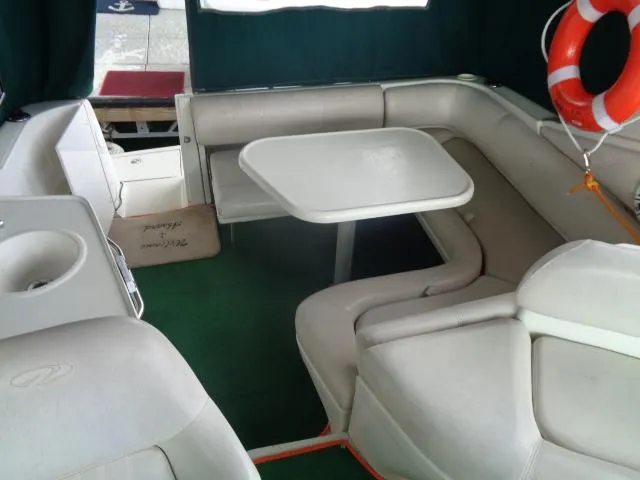 Slide: The Image of Interior of 1997 Regal 292 Commodore boat with seating and table. - 1
