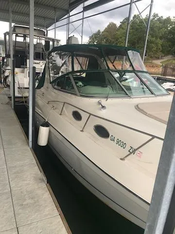 Slide: The Image of 1997 Regal 292 Commodore boat docked in a marina. - 12
