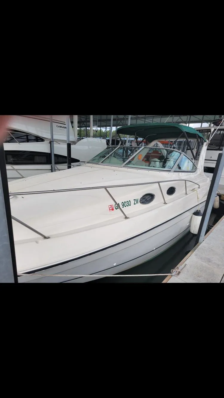 Slide: The Image of 1997 Regal 292 Commodore boat docked in a marina. - 15