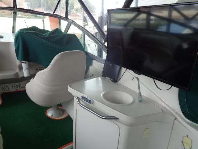 Slide: The Image of 1997 Regal 292 Commodore boat interior with TV, sink, and captain's chair. - 17