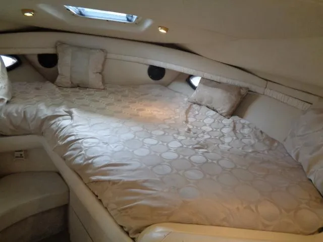 Slide: The Image of Luxurious cabin interior of a 1997 Regal 292 Commodore yacht with a cozy bed. - 21