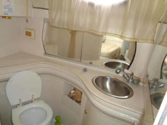 Slide: The Image of Bathroom interior of 1997 Regal 292 Commodore boat with sink and toilet. - 26
