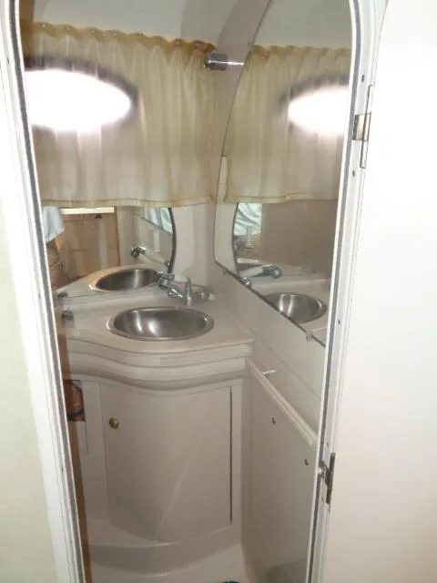 Slide: The Image of 1997 Regal 292 Commodore bathroom with dual sinks and mirrors. - 27