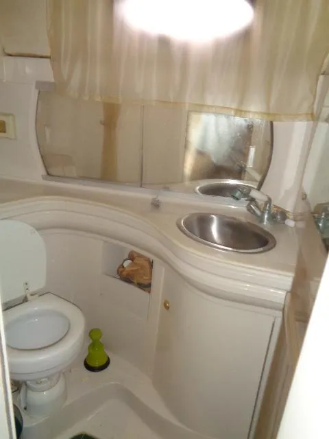 Slide: The Image of 1997 Regal 292 Commodore boat bathroom with sink, toilet, and mirror. - 28