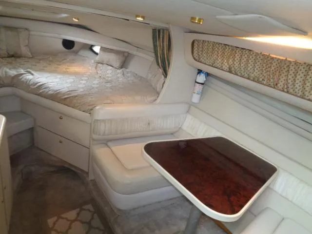 Slide: The Image of 1997 Regal 292 Commodore cabin interior with bed, seating, and table. - 6